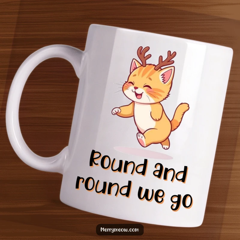 Funny mug featuring a ginger kitten with reindeer antlers joyfully chasing its tail, capturing holiday spirit.