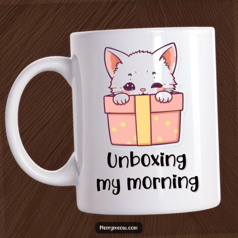 Funny mug showcasing a cute kitten playfully peeking out from a colorful, open gift box, filled with charm.