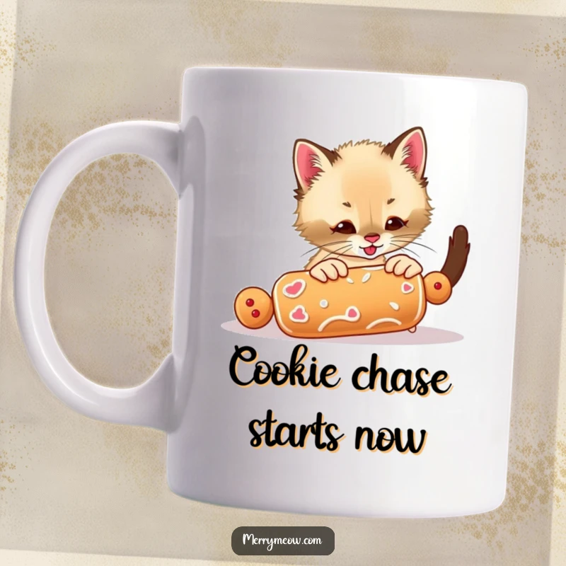 Funny mug depicting an excited Siamese kitten gleefully batting at a rolling gingerbread cookie, embodying playful holiday energy.