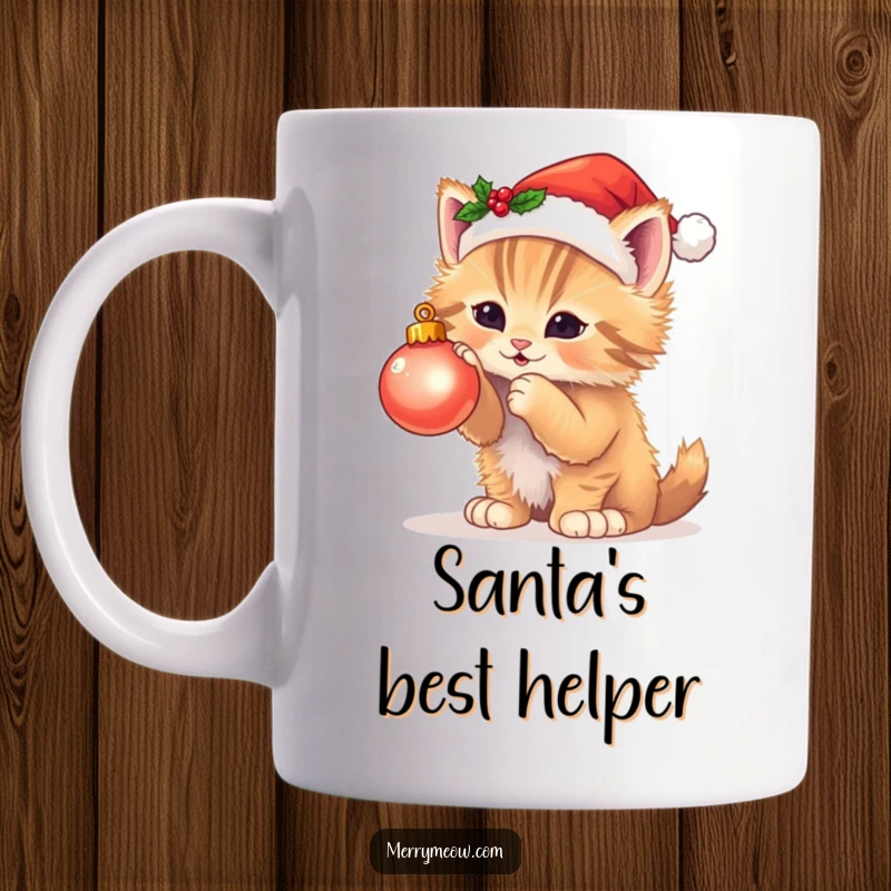 Funny mug featuring a fluffy kitten in a Santa hat playfully batting at a twinkling Christmas ornament, capturing holiday mischief.