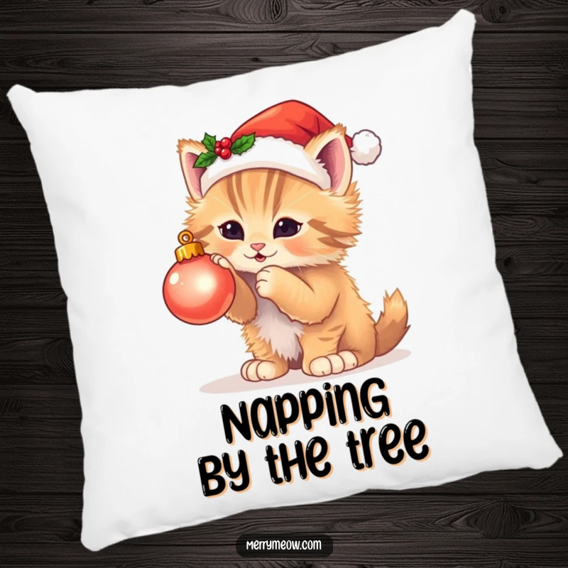 Funny pillow featuring a fluffy kitten in a Santa hat batting at a twinkling Christmas ornament, perfect for festive comfort.