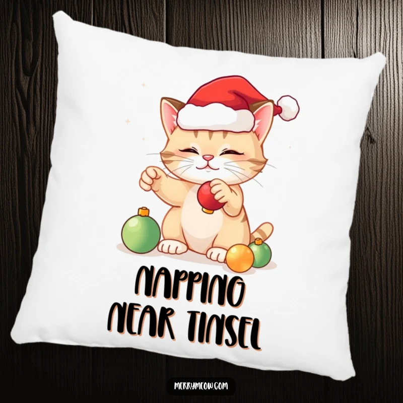 Funny festive cat pillow featuring a cute cat in a Santa hat, happily playing with Christmas ornaments, perfect for holiday decor.