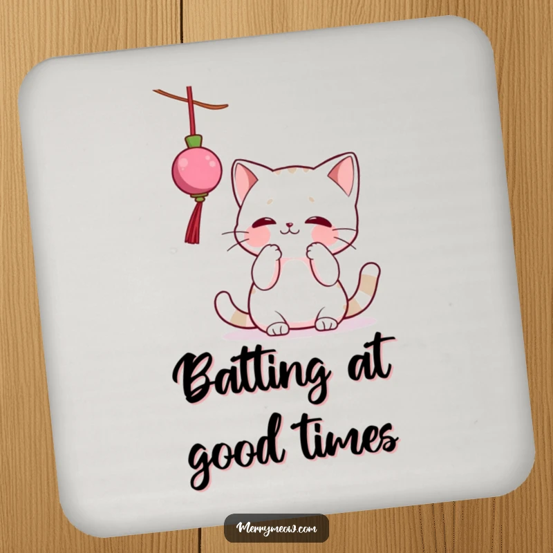 Funny drink coaster featuring a cat character playfully batting at a dangling Christmas ornament, adding festive humor to any table.