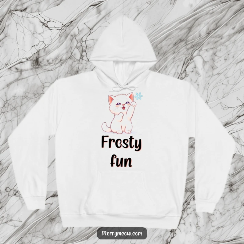 Funny hoodie with a white kitten joyfully batting at a falling snowflake, embodying pure winter delight.