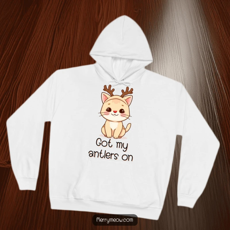 Funny reindeer cat hoodie featuring a charming feline in festive reindeer attire, its red nose glowing with holiday cheer.