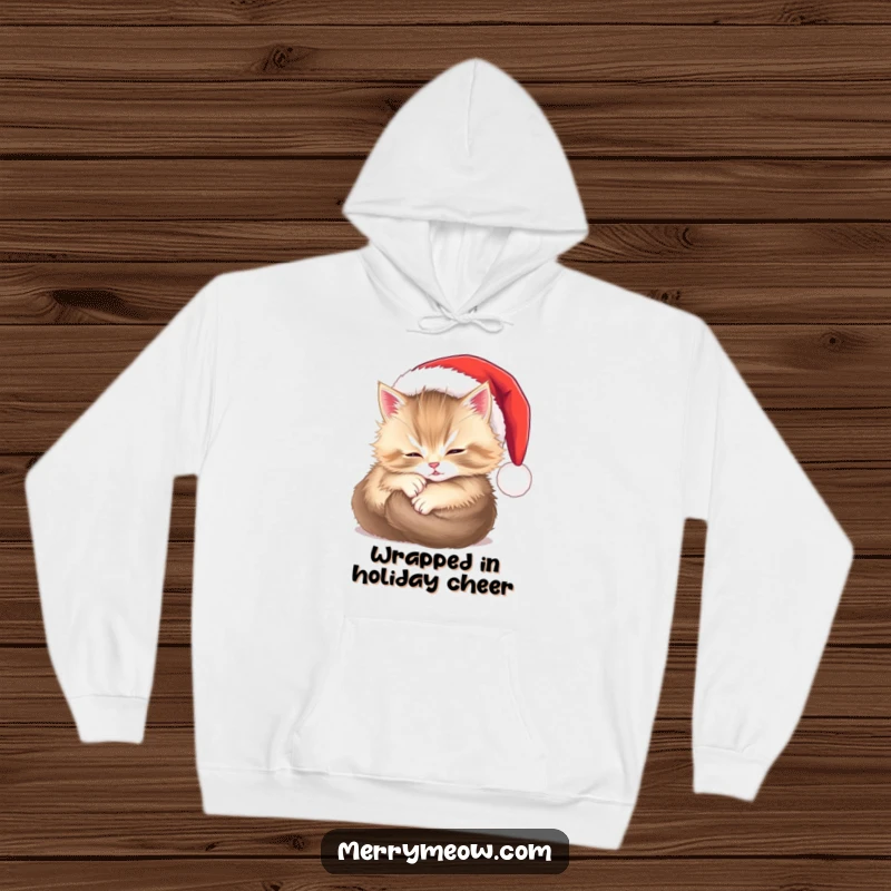 Funny hoodie depicting a content, fluffy kitten snoozing peacefully inside a small Santa hat, radiating warmth and holiday cheer.