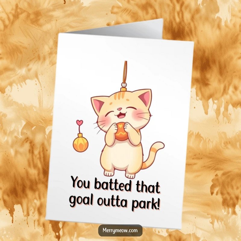 Funny Free Printable Congrats Card: A playful cat character batting at a shiny dangling ornament, celebrating success.
