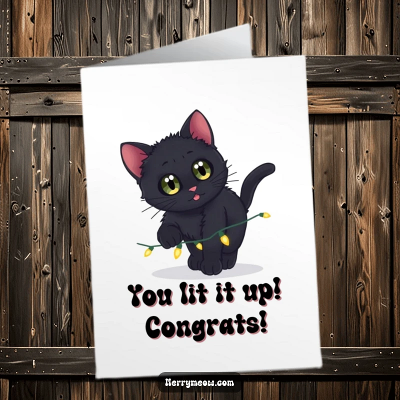 Funny Free Printable Congratulations Card: A wide-eyed black kitten playfully pounces on a string of shiny twinkling lights.