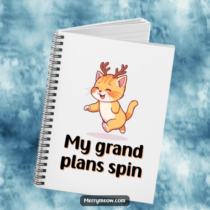 Funny notebook featuring a ginger kitten in reindeer antlers chasing its tail, ideal for holiday planning.