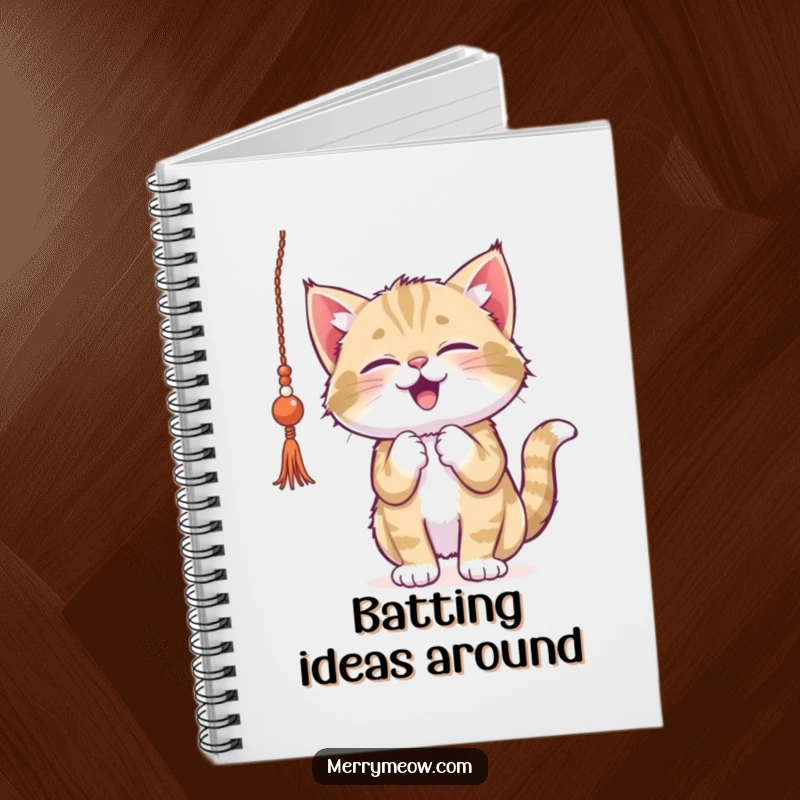 Funny kitten notebook, gleefully batting at dangling tinsel, perfect for jotting down festive ideas or playful holiday plans.