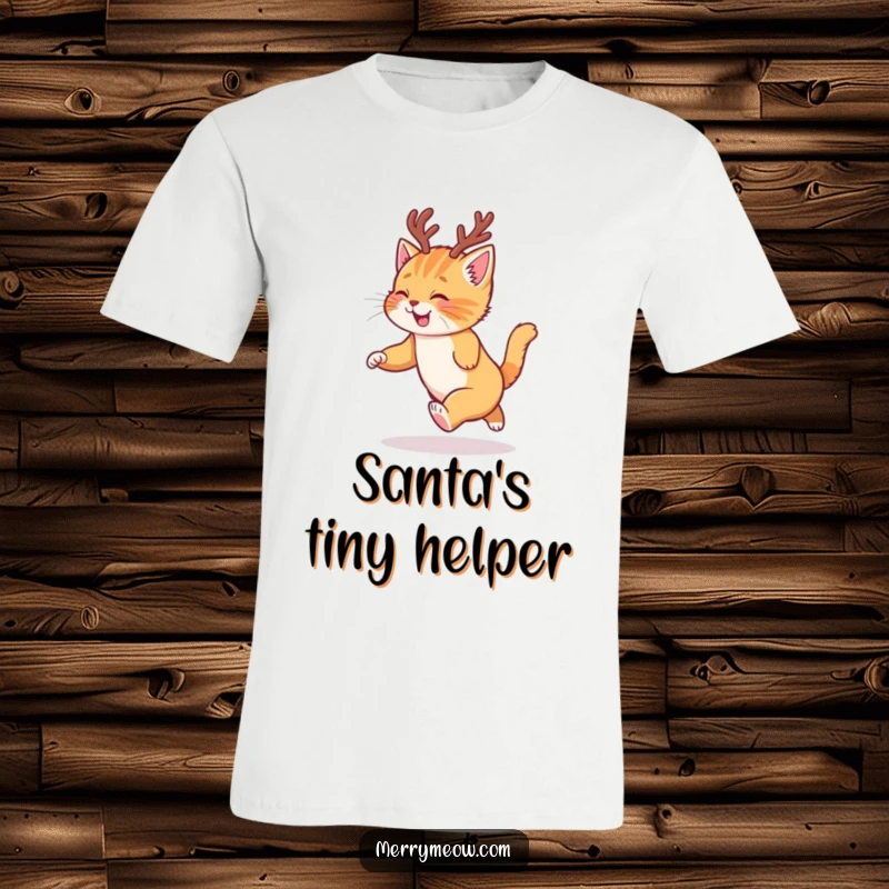 Funny t-shirt with a cute ginger kitten wearing tiny reindeer antlers, gleefully chasing its tail during Christmas.