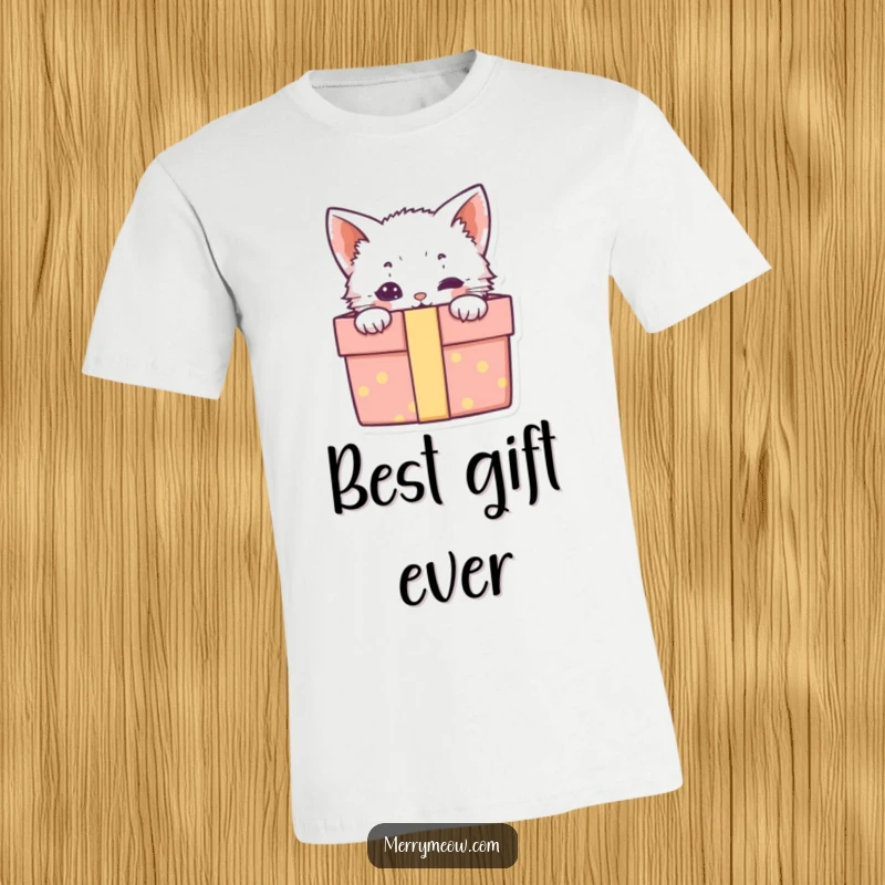 Funny t-shirt with a charming kitten peeking from an open gift box, embodying playful surprise and irresistible cuteness.