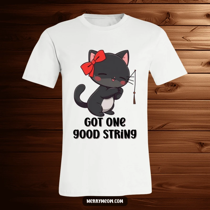 Funny T-Shirt: A sleek black cat wearing a red ribbon playfully swats at a dangling string, looking adorably mischievous.