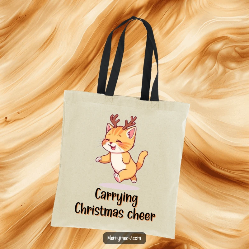 Funny tote bag with a happy ginger kitten wearing reindeer antlers, chasing its tail with festive glee.