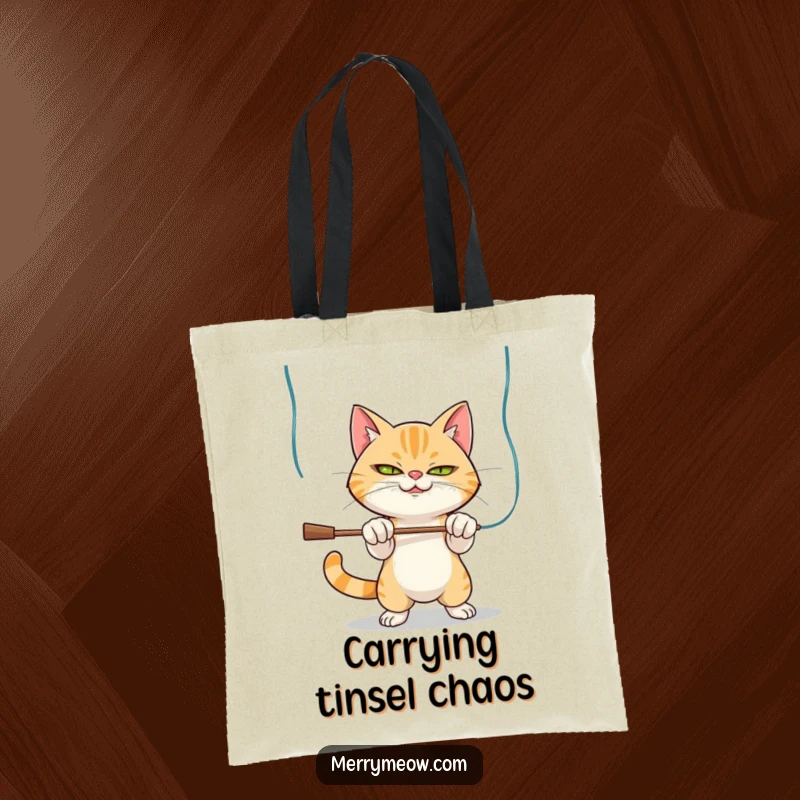 Funny Tote Bag: Mischievous cat character batting at tinsel, designed for holiday lovers and cat enthusiasts.
