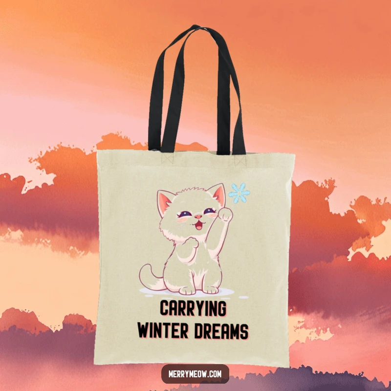 Funny tote bag featuring a white kitten batting happily at a falling snowflake, perfect for winter outings.