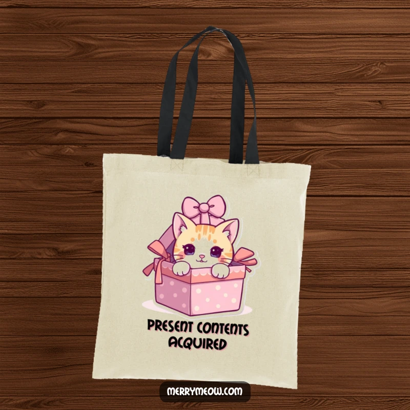 Funny cat peeking out of a gift box on a reusable tote bag, practical and humorous.